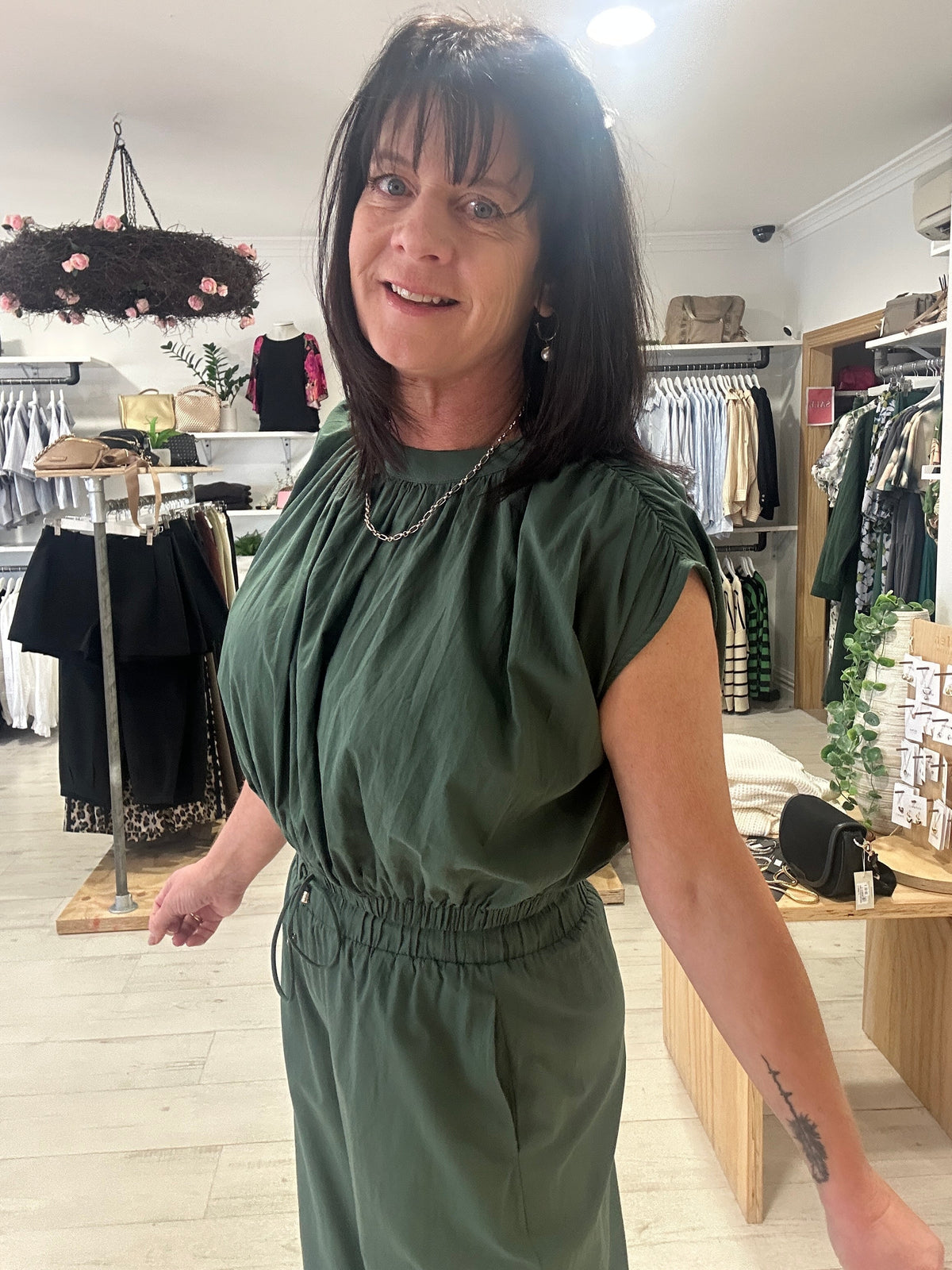 Owner of Absolutely Boutique wearing new season women’s fashion in store, New Zealand”